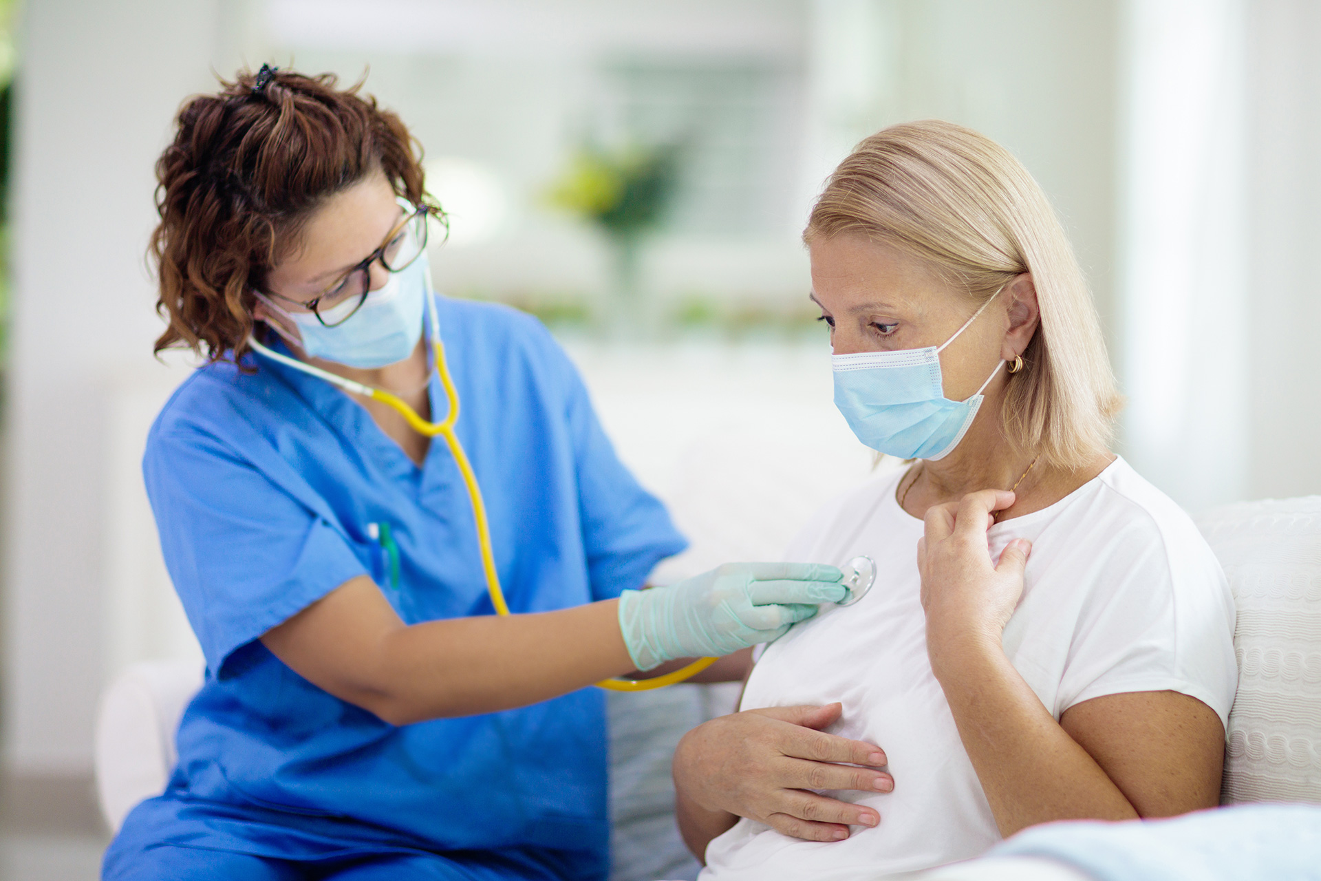 Doctor Examining Sick Patient in Face Mask